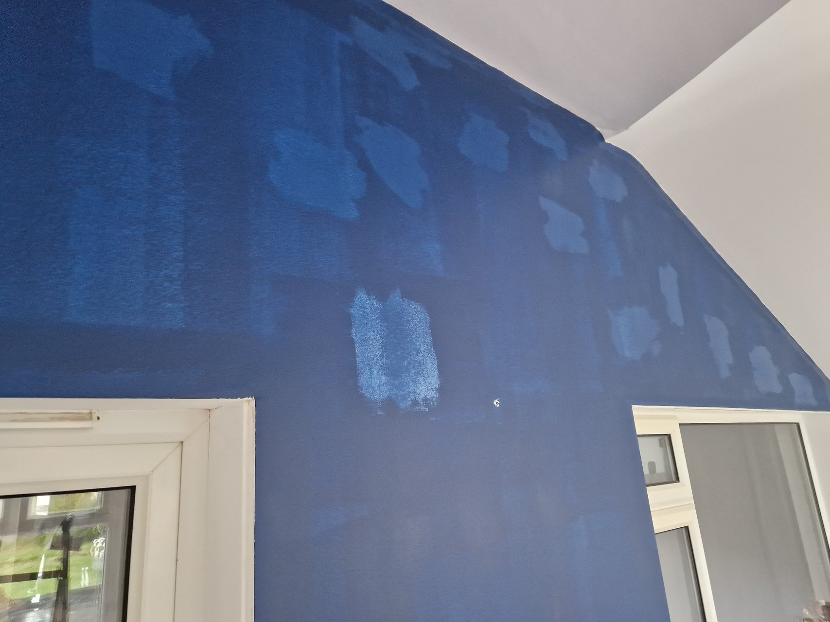 Feature wall with first coat after stain block